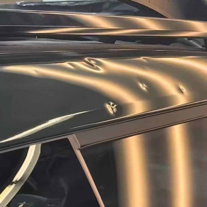 Roof and hood with hail dents