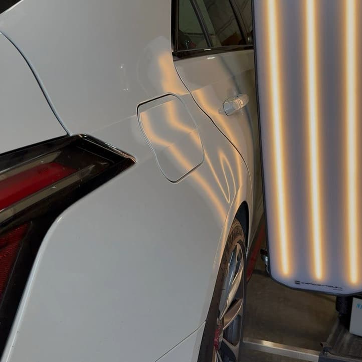 Door panel after paintless dent repair—like new